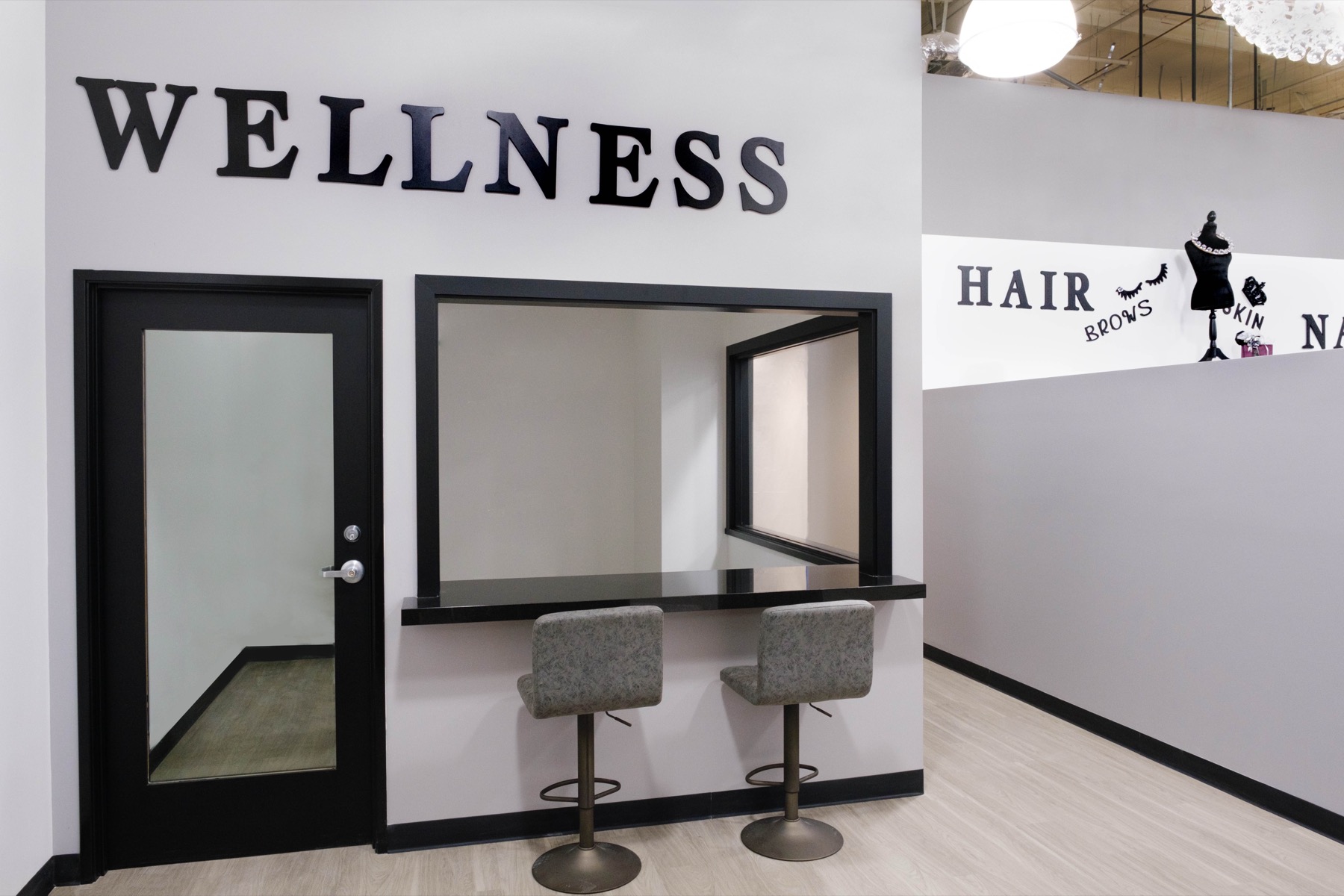 Private wellness room with two stools and a service counter